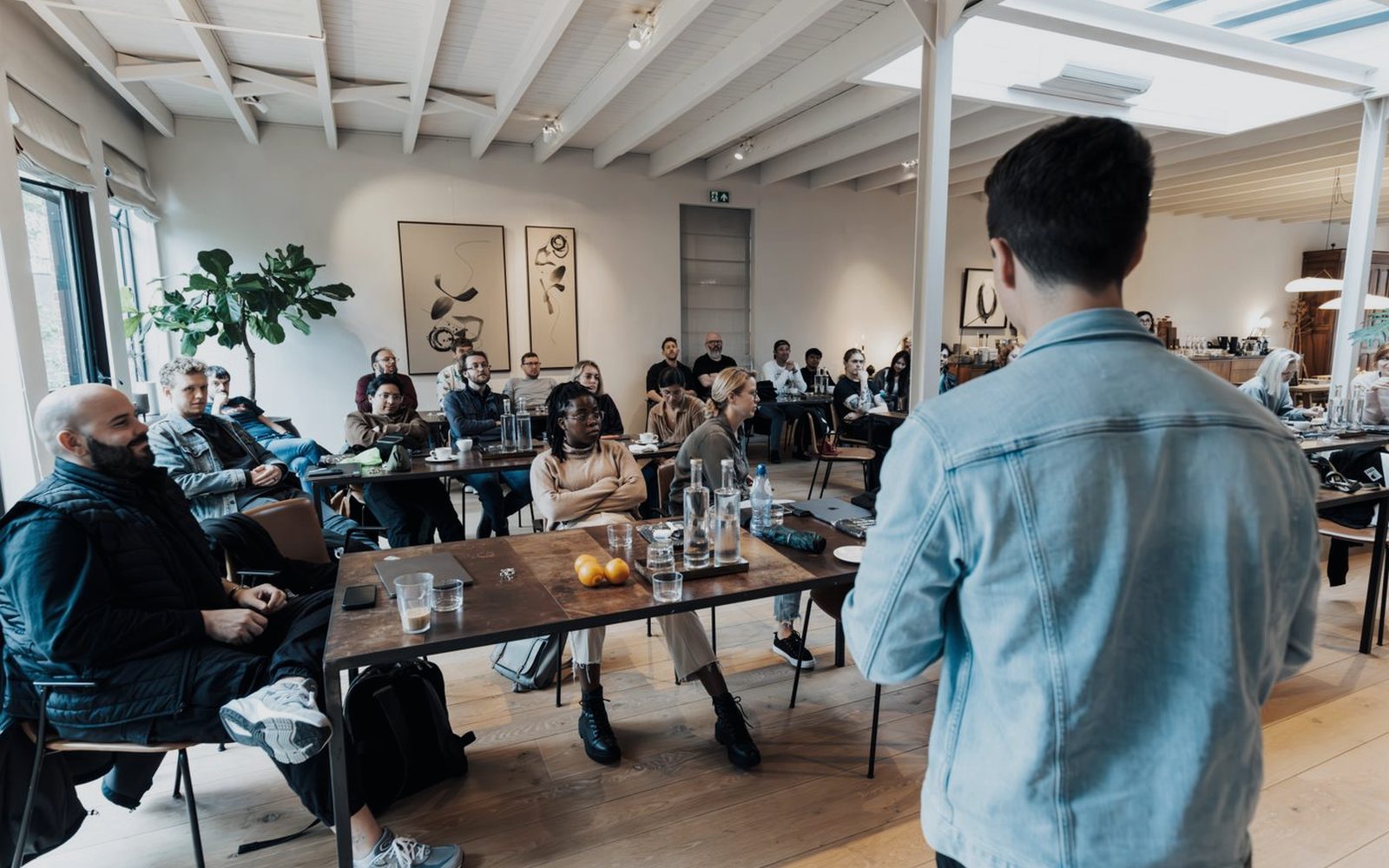 A strategist presenting campaign findings to a small business team around a table.