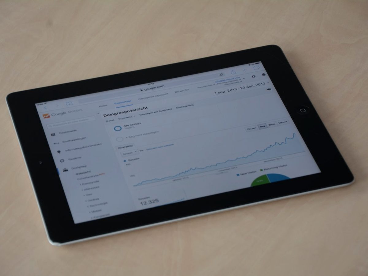 A tablet displaying a website analytics dashboard with an organic traffic trend line.
